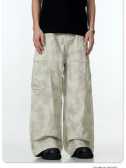 Relaxed fit beige cargo pants with multiple pockets and a tie-dye effect.