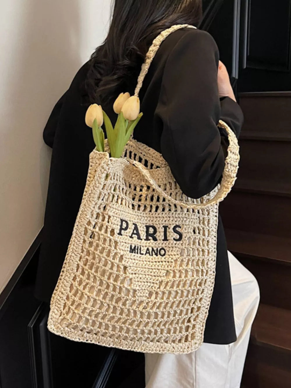 Off-white crochet knit tote bag with "PARIS MILANO" text and shoulder straps.