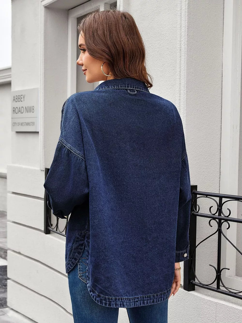 Dark blue denim trucker jacket with button-down front and chest pockets.
