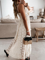 White lace V-neck maxi dress with ruffles and a tiered skirt.