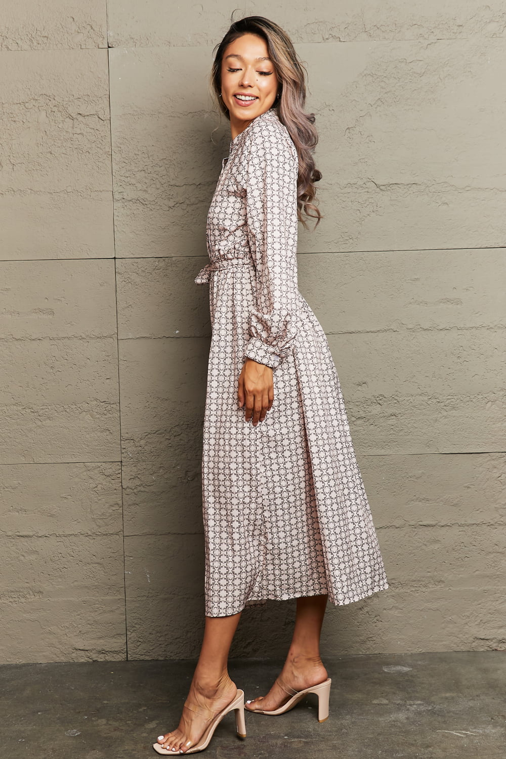 Beige geometric print midi dress with belt, long sleeves, and A-line cut.