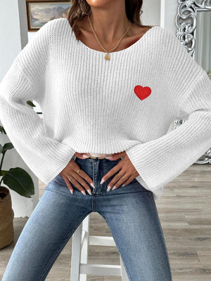 White knit boatneck sweater with embroidered red heart detail.