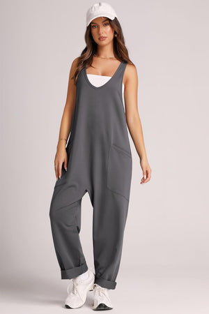 Relaxed fit dark gray jumpsuit with V-neck, oversized pockets, and cuffed legs.