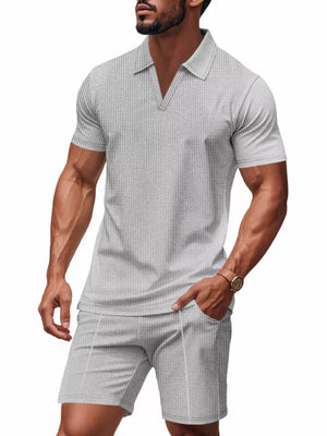 Men's grey textured polo shirt and shorts ensemble with a V-neck and short sleeves.