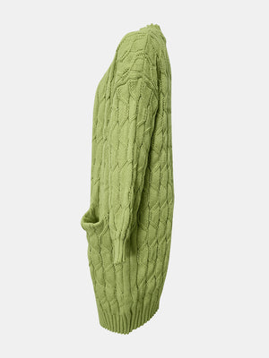 Green cable knit duster cardigan with pockets and textured acrylic knit.