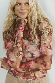 Sheer floral mock neck top with long sleeves and a second-skin fit.