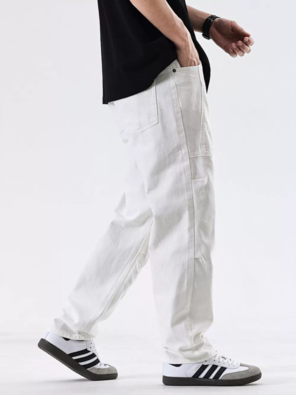 Men's white cotton jeans with a relaxed fit and pocket detail.