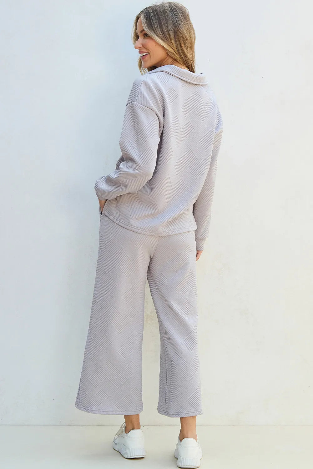 Gray quilted knit collared loungewear set with textured geometric pattern and wide leg pants.