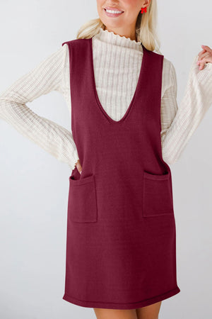 Burgundy knit sweater dress with deep V-neck and two front pockets.