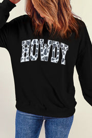 Black crewneck sweatshirt with cow print "Howdy" graphic, 30% cotton, 70% polyester.