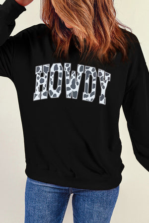 Black crewneck sweatshirt with cow print "Howdy" graphic, 30% cotton, 70% polyester.