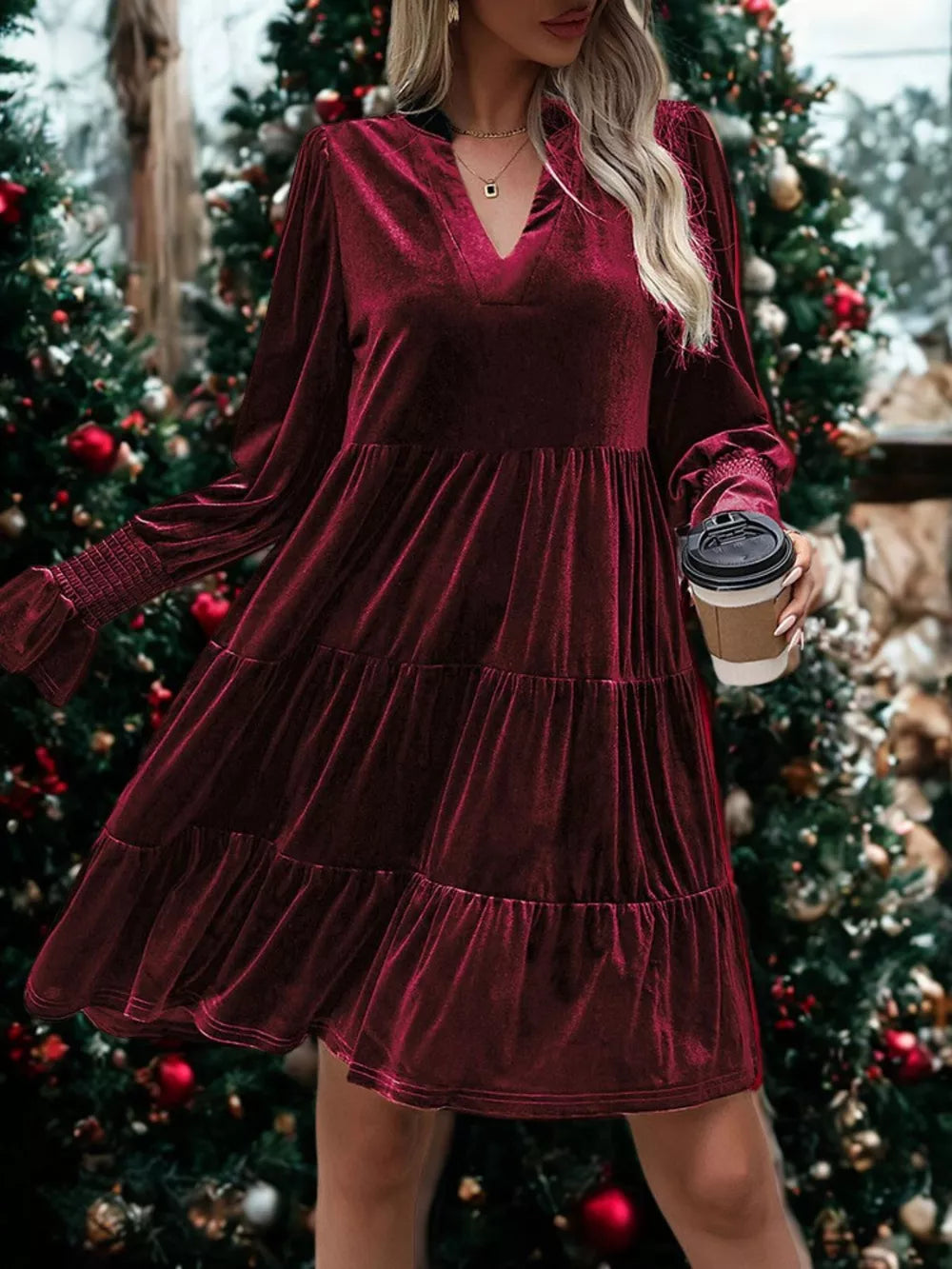 Burgundy velvet tiered mini dress with V-neck and smocked cuffs.