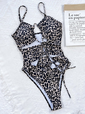 Leopard print one-piece swimsuit with cutout details and lace-up front.