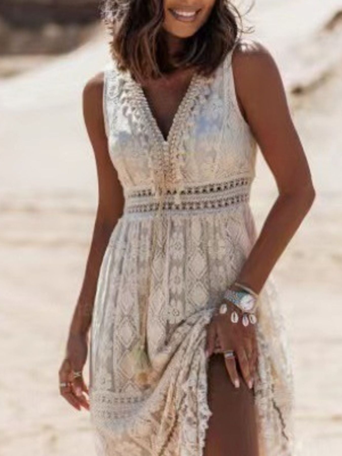 White lace V-neck maxi dress with crochet detail and a high slit.