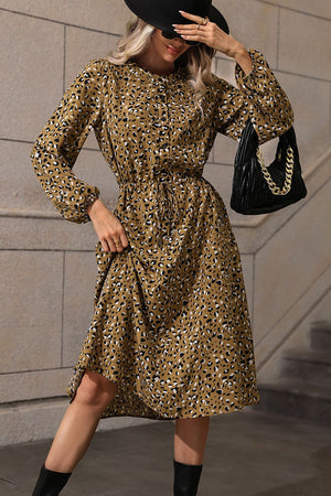 Gathered waist animal print midi dress in olive with long sleeves and a tie belt.