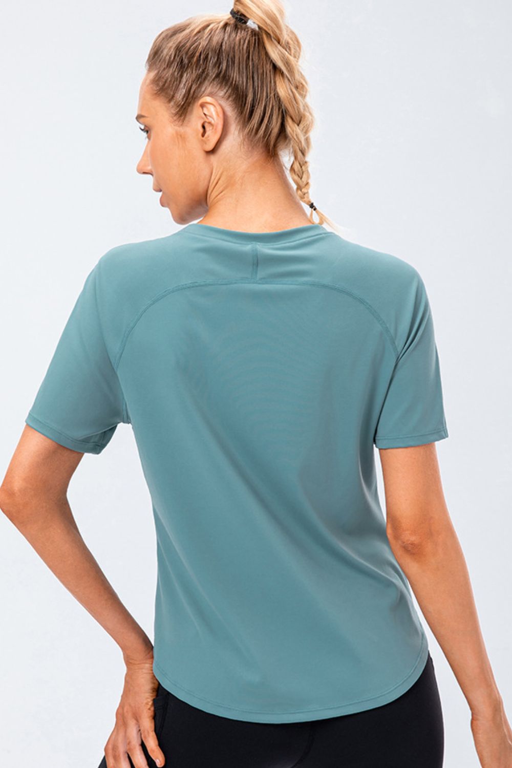 Teal performance raglan crew neck tee with short sleeves and curved hem