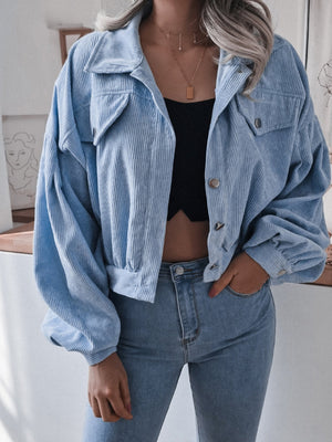 Blue corduroy cropped jacket with balloon sleeves and button-up front.