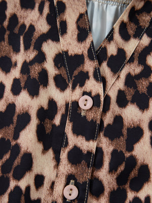 Women's buttoned shirt with leopard print and lace trim detail.