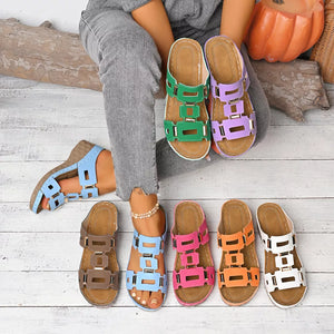 Chic open-toe wedge sandals in multiple colors with cutout straps and gold buckle details.