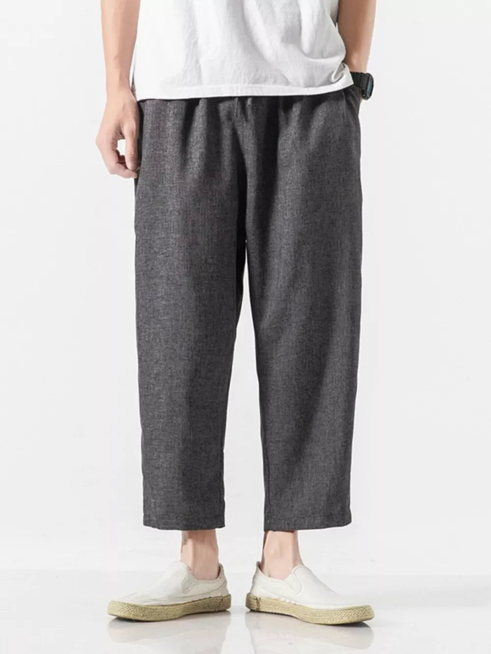 Men's dark gray relaxed fit cropped sweatpants with elastic waistband.