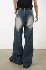 Faded wash palazzo jeans in medium denim with a wide leg and distressed detailing.