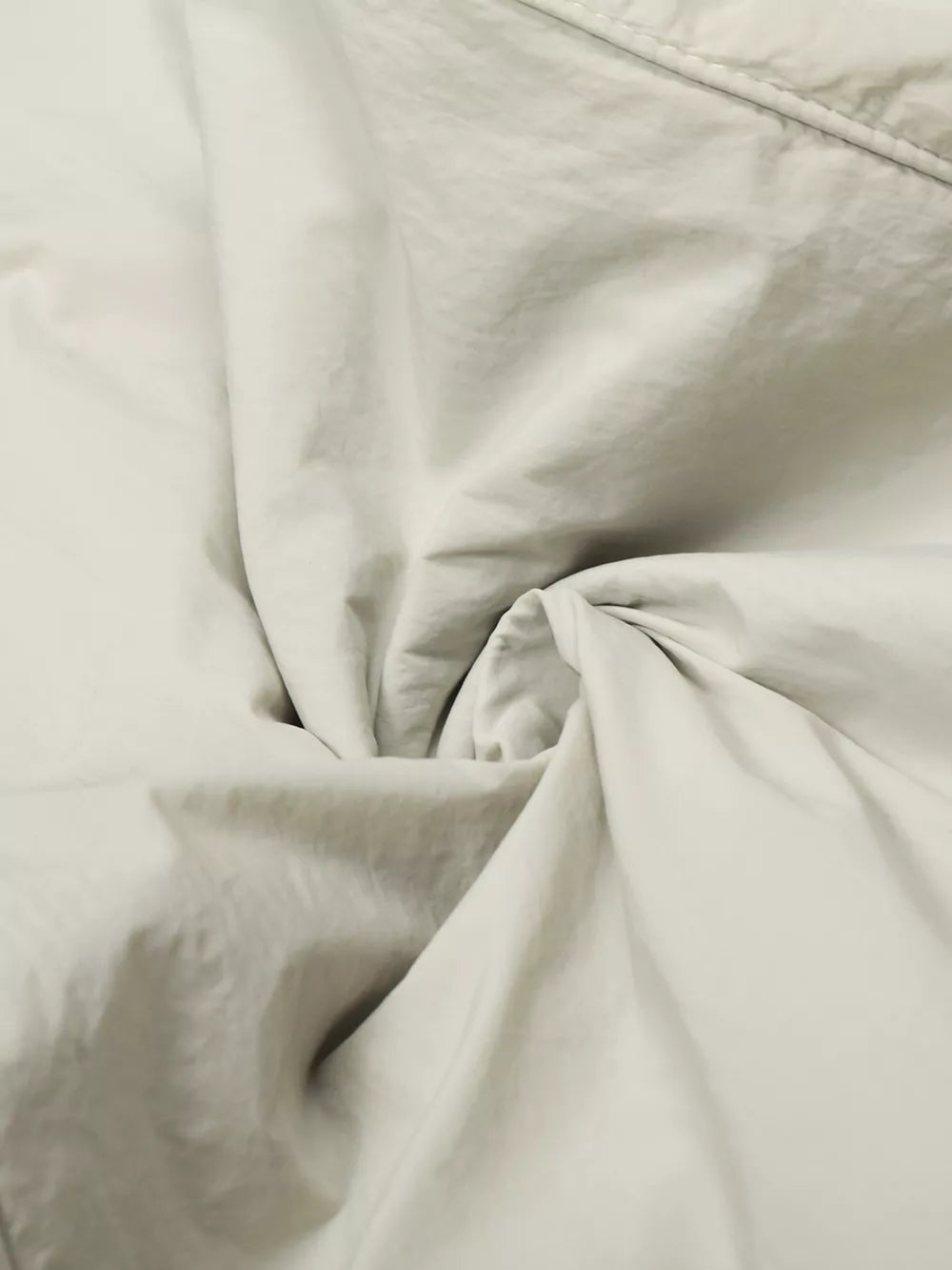 Men's wide-leg sweatpants in light gray with a crinkled texture.