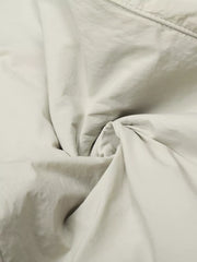 Men's wide-leg sweatpants in light gray with a crinkled texture.