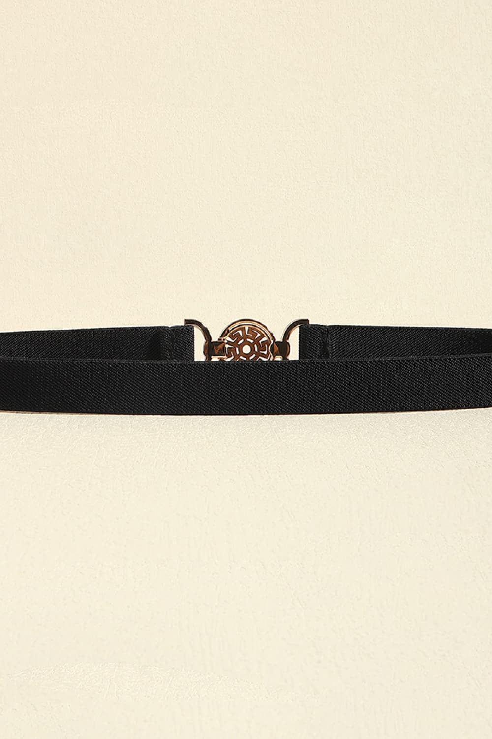 Black elastic belt with a round medallion buckle and alloy details