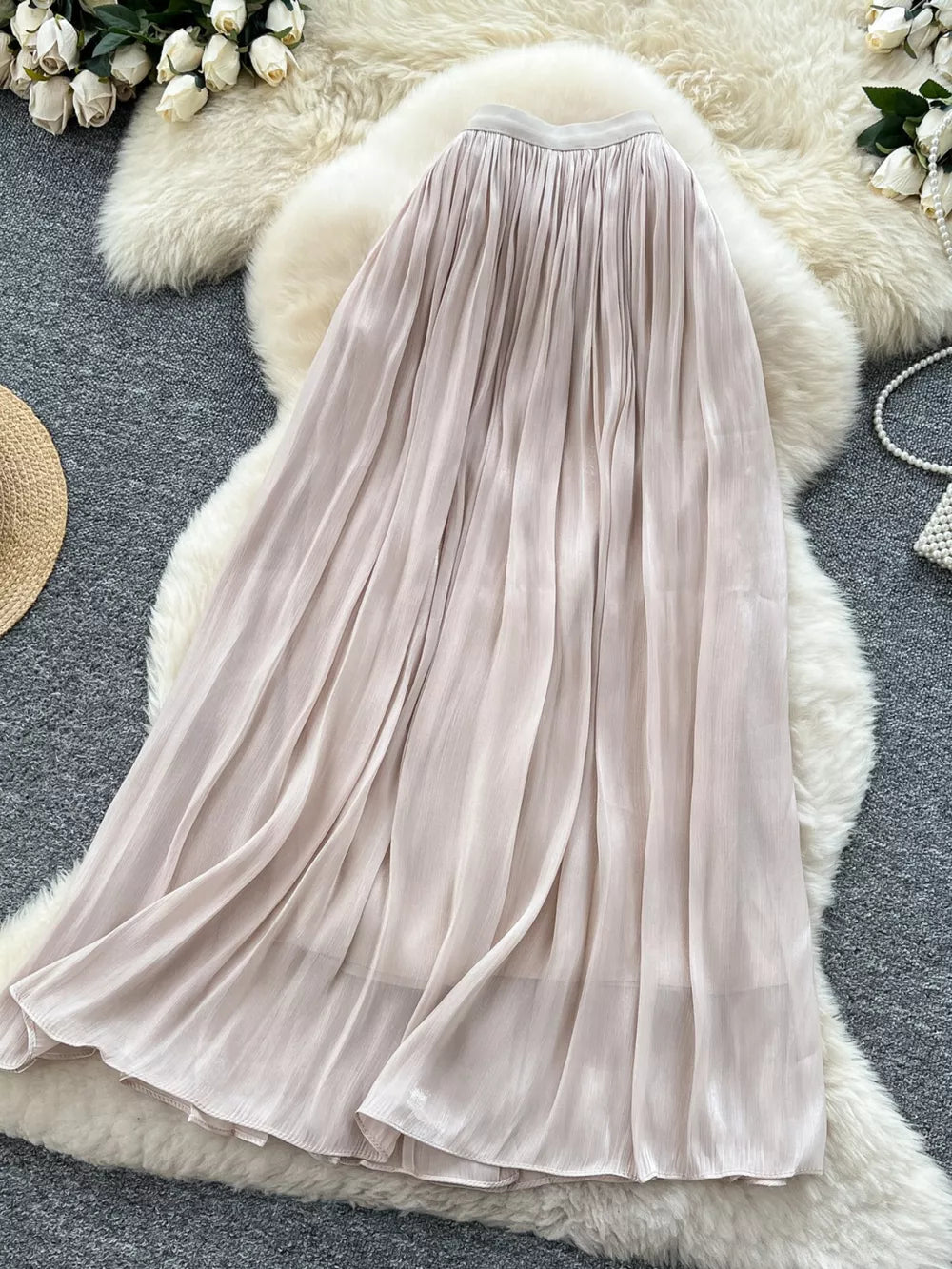 Pleated maxi skirt in cream with a flowing, elegant silhouette.