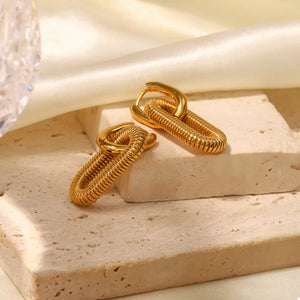 Gold link drop earrings with textured oval pendant and smooth hoop.