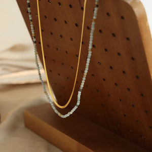 Gold layered necklace set with a snake chain and a beaded chain.
