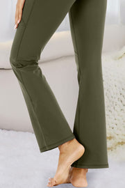 Army green flare-leg performance trousers with pockets and a relaxed fit.