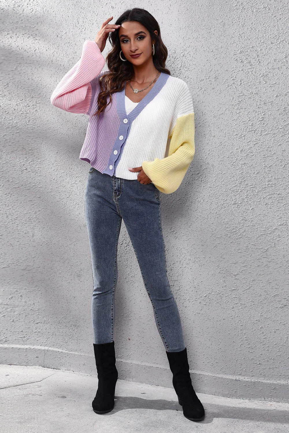 Colorblock knit cardigan with balloon sleeves in white, pink, purple, and yellow.