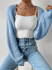 Light blue acrylic knit bolero shrug with long sleeves and ribbed texture.