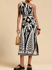 Black and white tropical print one-shoulder midi dress with defined waist and side slits.