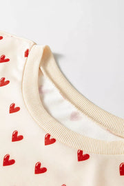 Heart Print Round Neck Long Sleeve Sweatshirt in Cream, model styling view