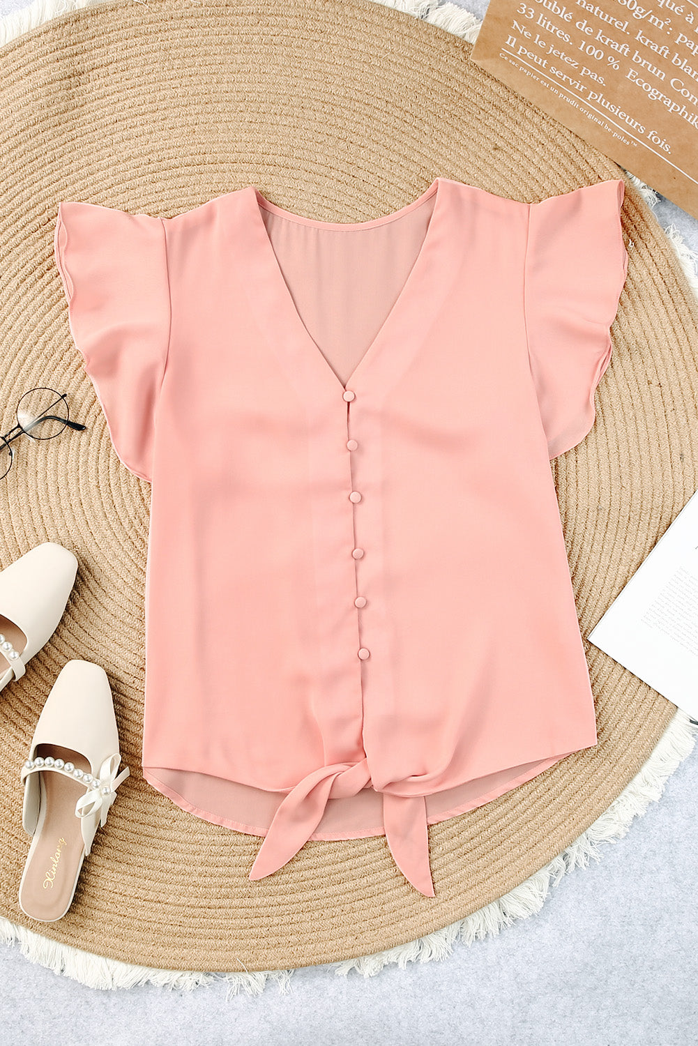 Peach tie-front blouse with ruffle sleeves and button-down V-neck.