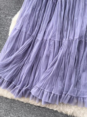 Purple tiered tulle skirt with ruffled hem and lining, showing fabric texture.
