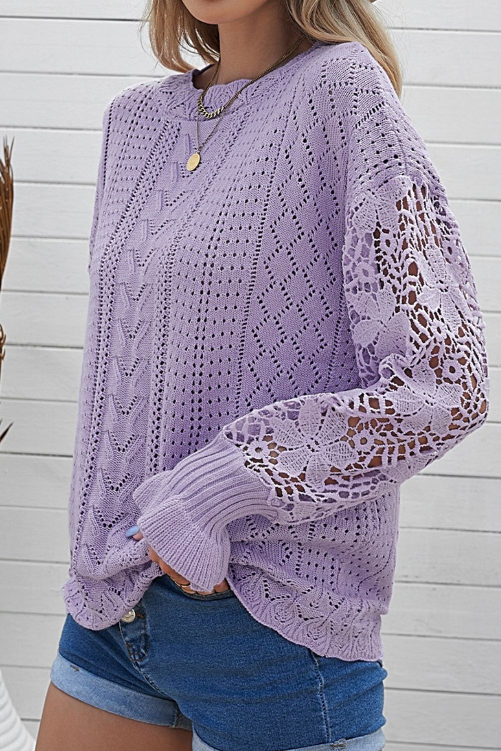 Lavender openwork knit sweater with lace sleeves and crew neck.