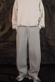 Relaxed-fit lounge trousers in dark gray with a drawstring waist and pockets.