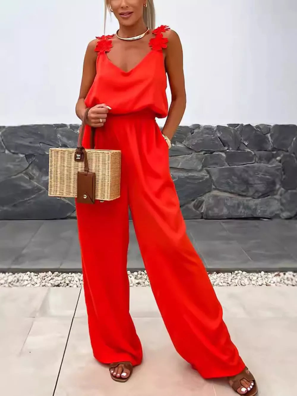 Red floral applique wide-leg maternity jumpsuit with V-neck and blouson waist.