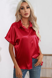 Scarlet satin button-down blouse with cuffed short sleeves.
