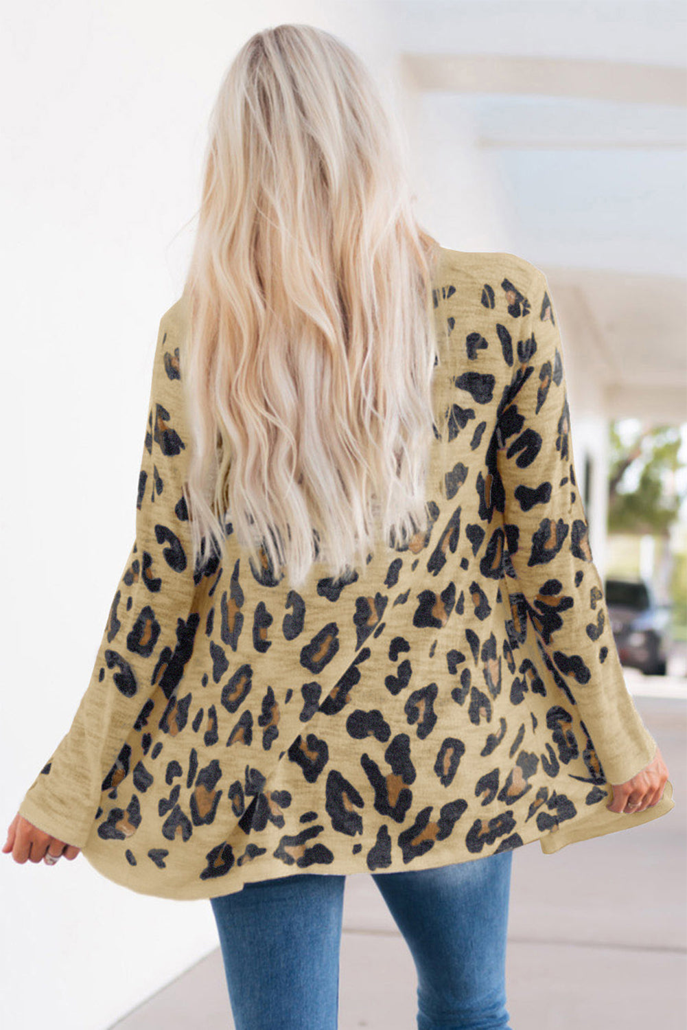 Tan leopard print open-front knit cardigan with bell sleeves.