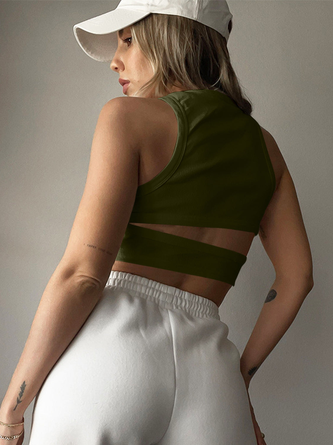 Moss green ribbed crop top with cutout back detail and high neckline.