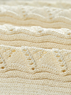 Ribbed knit maxi dress in pastel yellow with decorative button details.