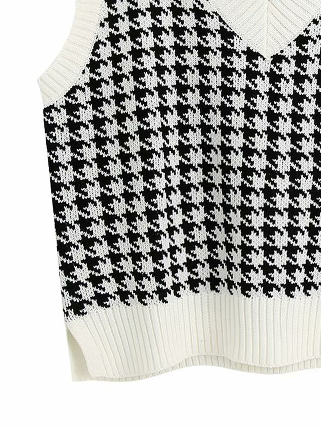 Houndstooth knit V-neck tank top in black and white with ribbed trim and side slits.