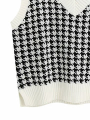 Houndstooth knit V-neck tank top in black and white with ribbed trim and side slits.