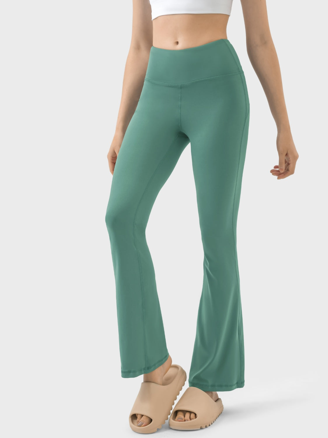 Flared sculpt leggings in turquoise with high-rise waist and v-seam detail.