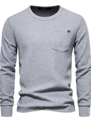 Gray textured thermal long sleeve tee with chest pocket and minimalist detail.