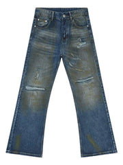 Distressed flare jeans in medium wash denim with patina effect and ripped details.